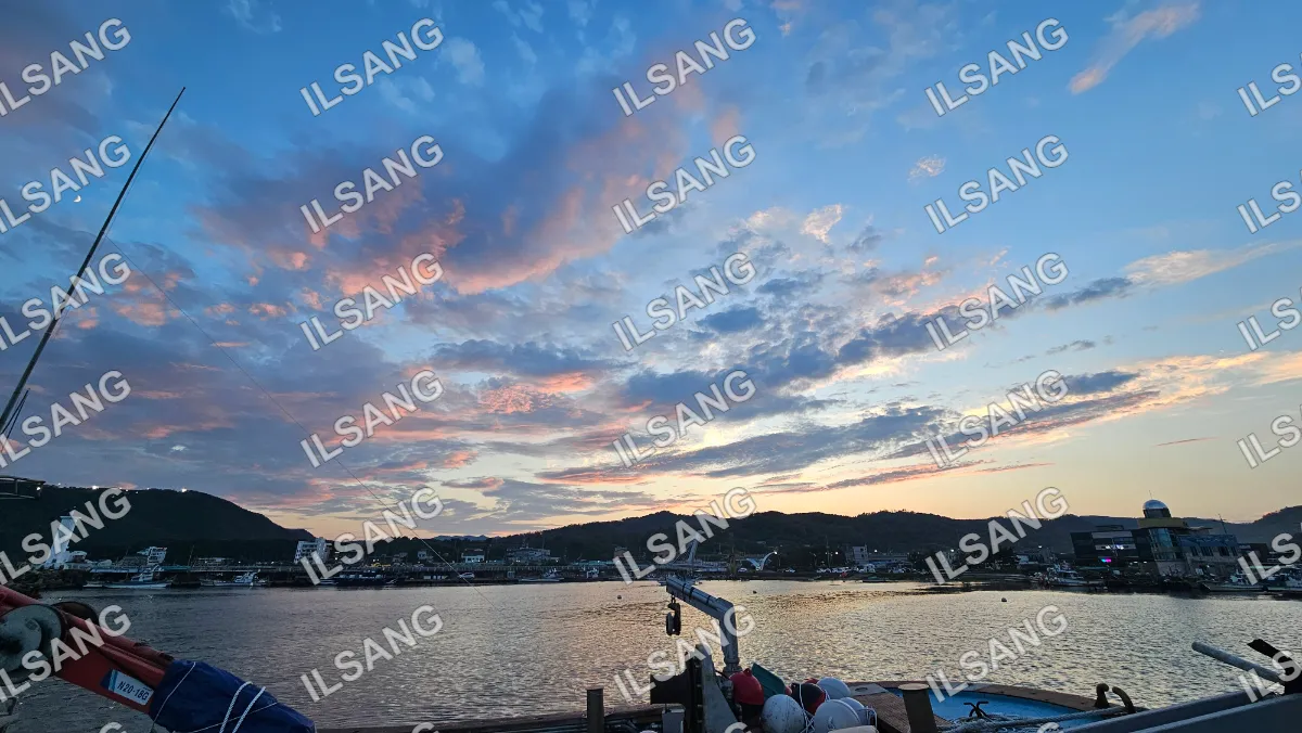 A beautiful sunset over a lake with a boat in the water.