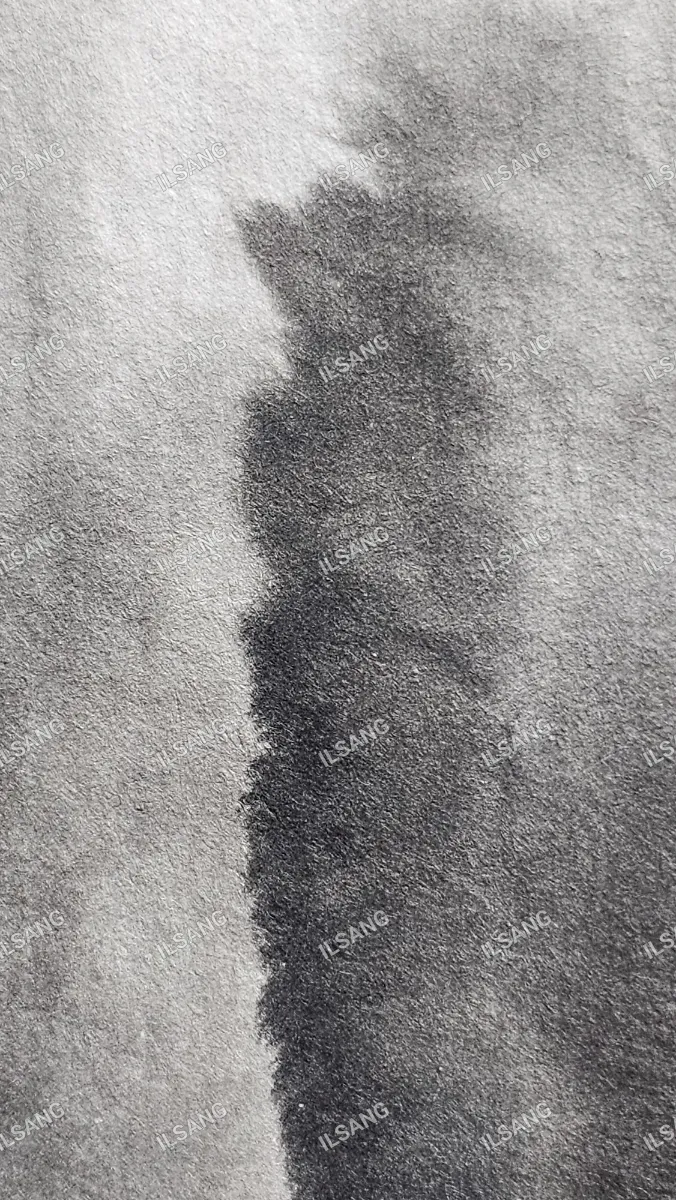 A black and white photo of a black mark on a gray background.