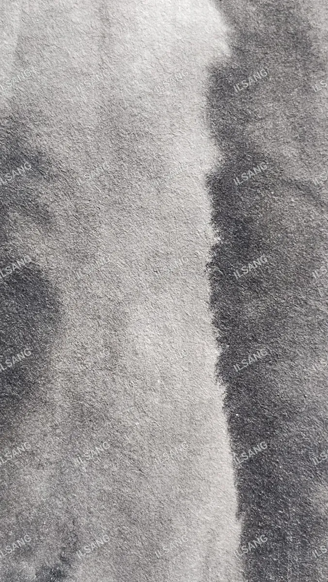 A black and white photo of a gray cloth with a white spot.