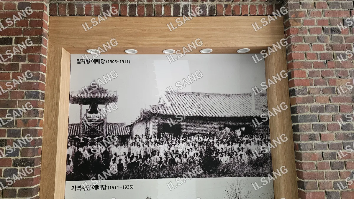 A black and white photo of a group of people in front of a building.