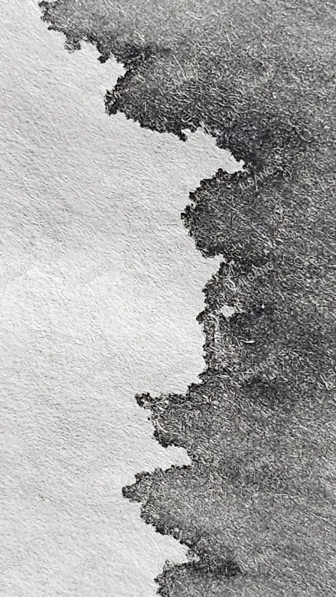 A black and white photo of a piece of paper with a hole in it.