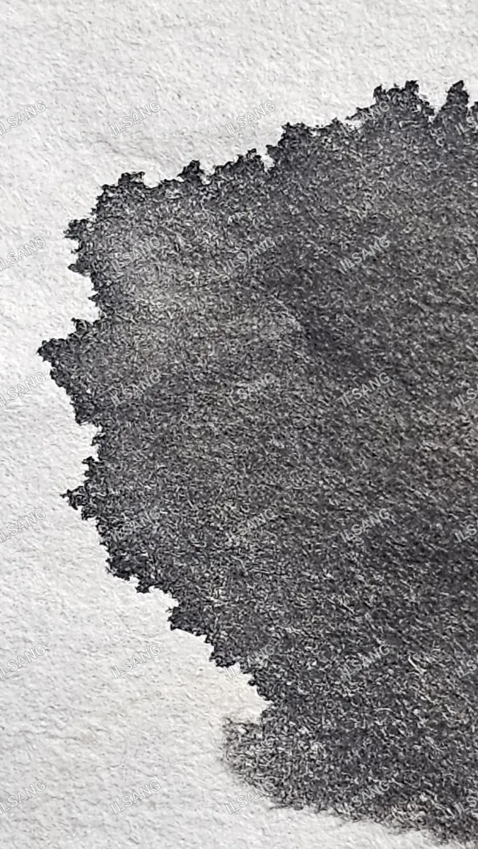 A black and white photo of a piece of paper with a hole in it.