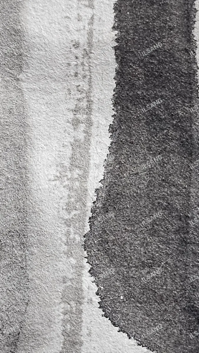 A black and white photo of a white cloth with a black spot.