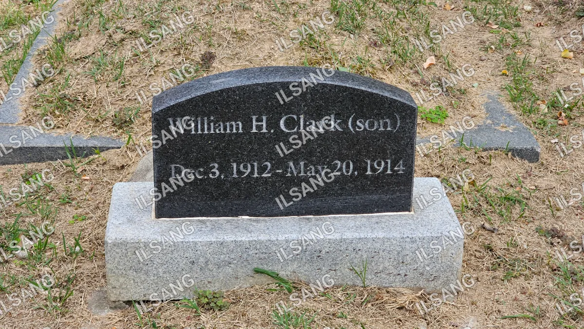 A black gravestone with the name William H. Clark.