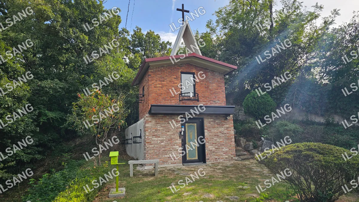 A brick church with a cross on top.