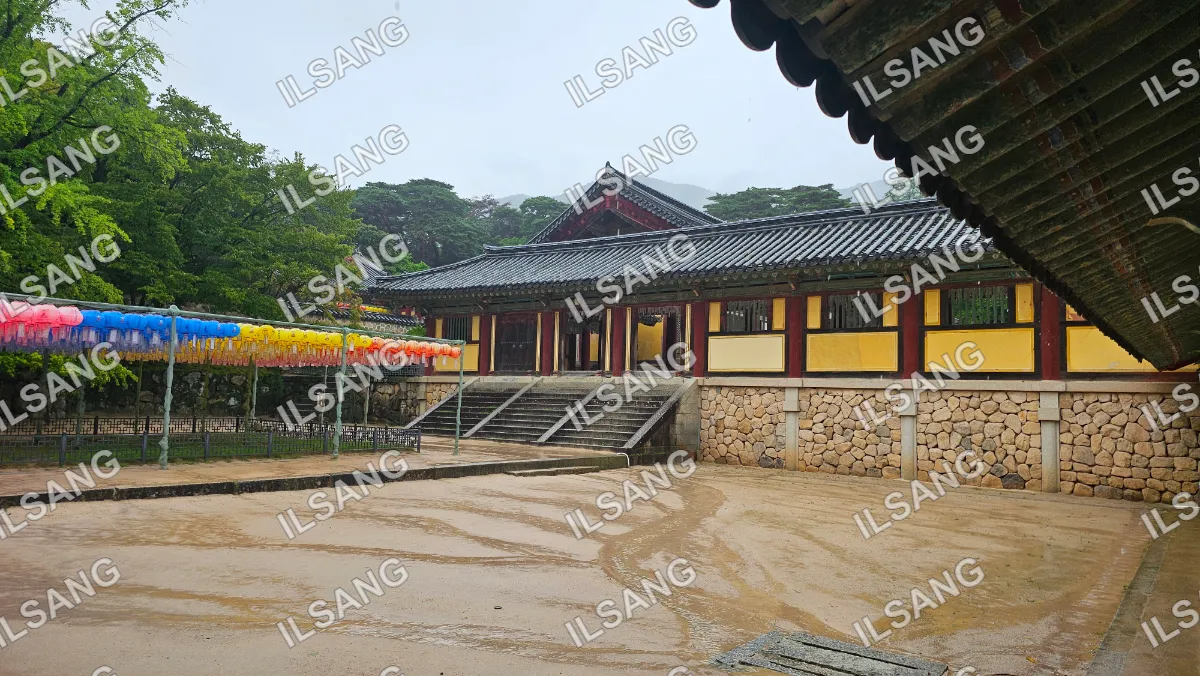 A building with a red roof and yellow banners.