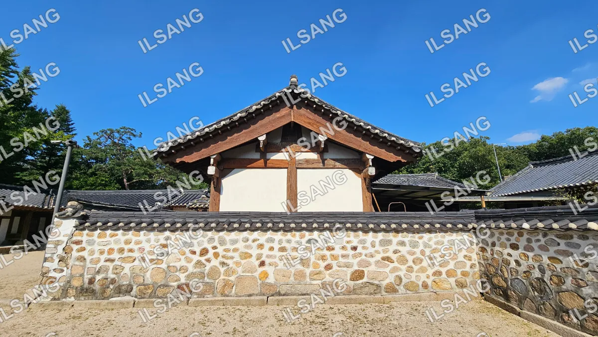 A building with a tile roof and a bird on top.