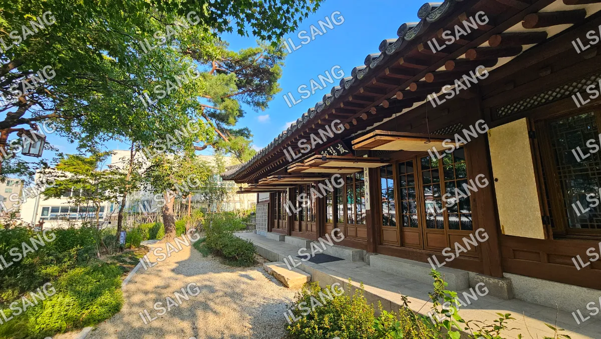 A building with a wooden roof and a stone wall.