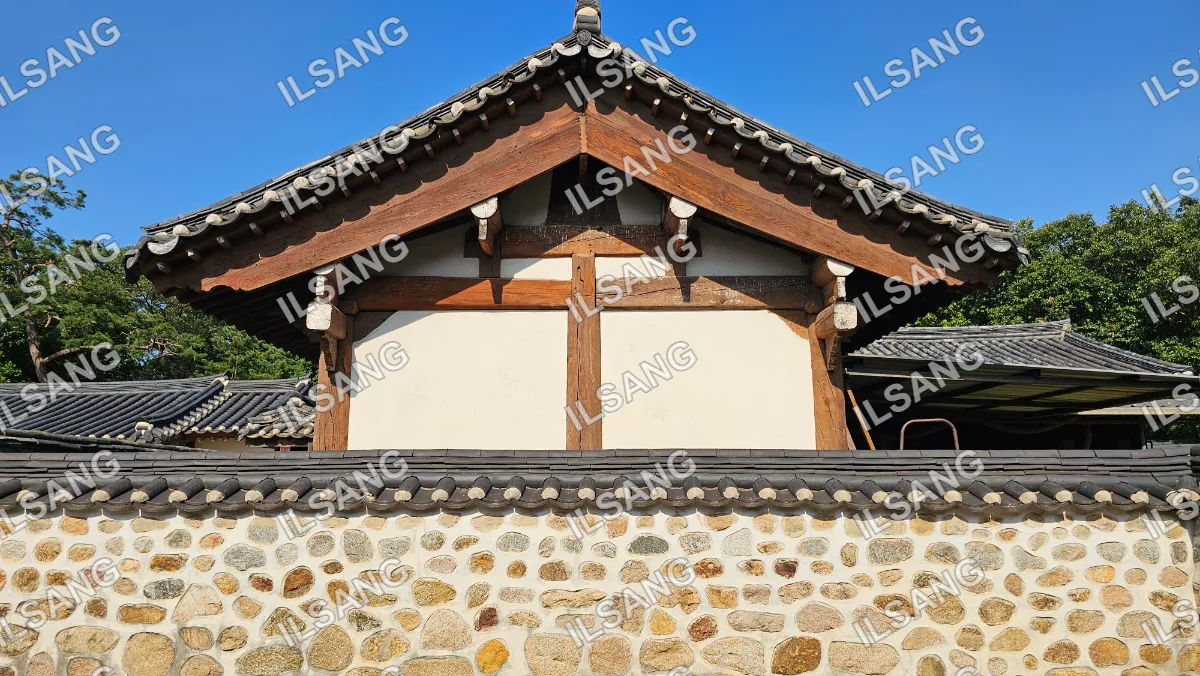 A building with a wooden roof and stone walls.