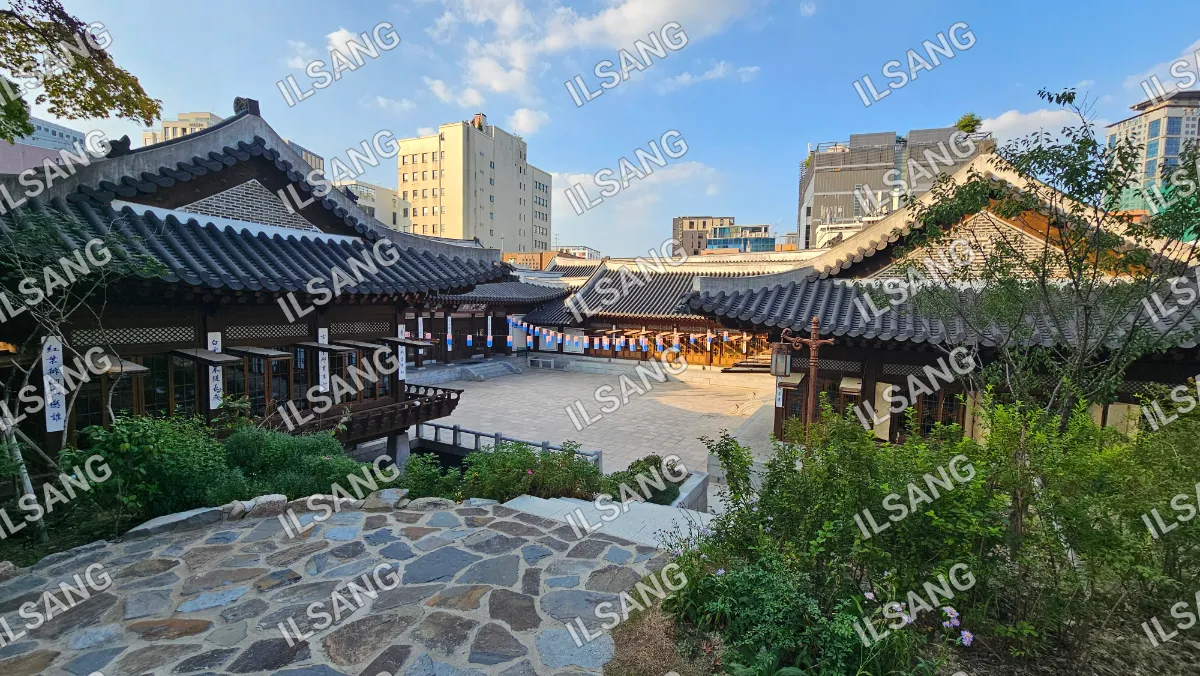 A city street with a building and a stone walkway.