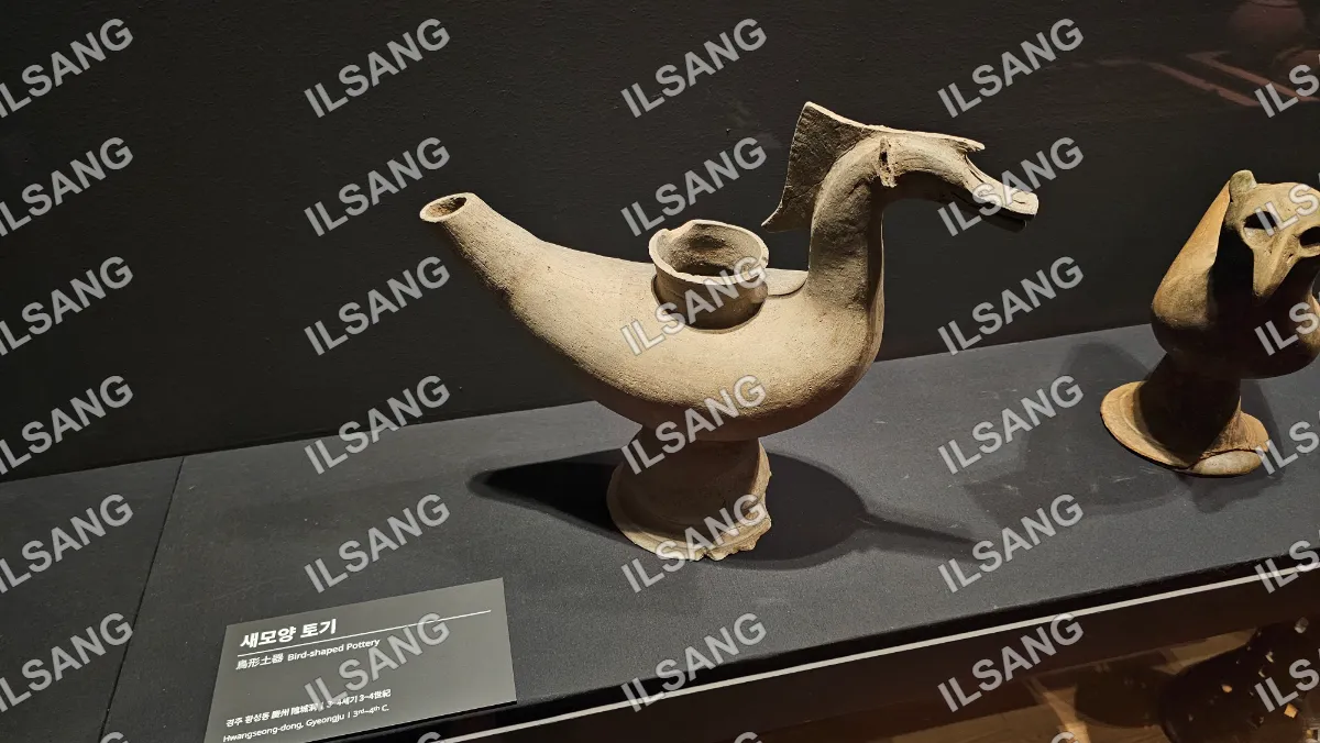 A clay sculpture of a dragon is on display.