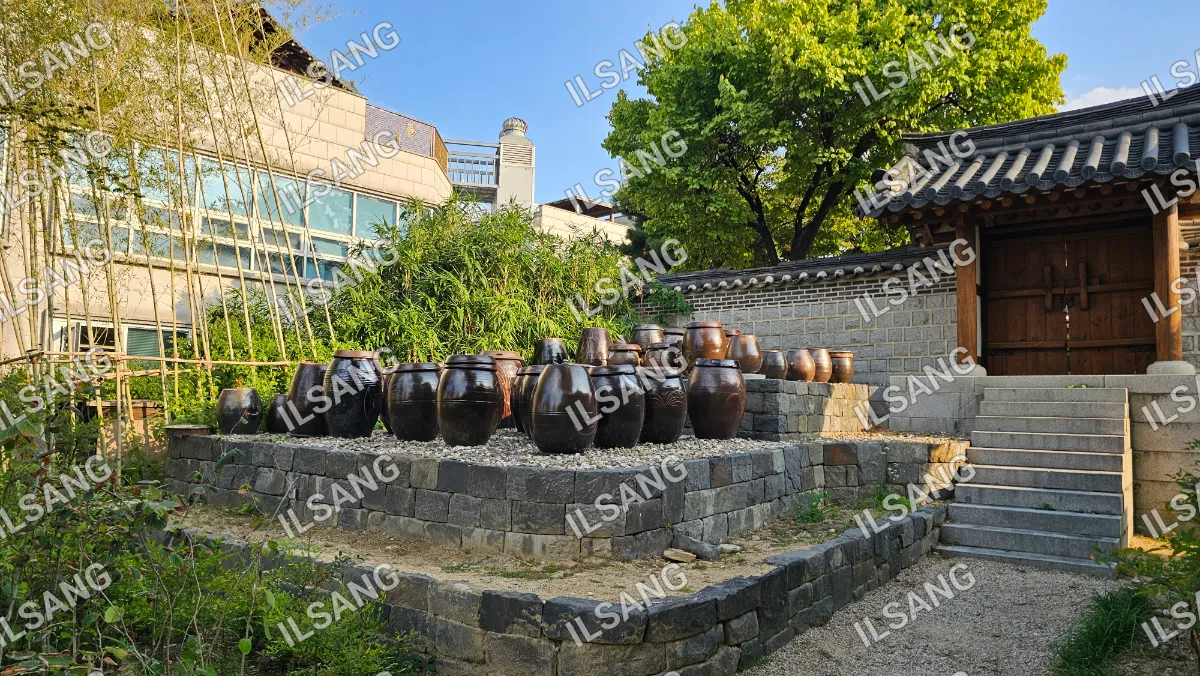 A collection of clay pots are displayed in a garden.