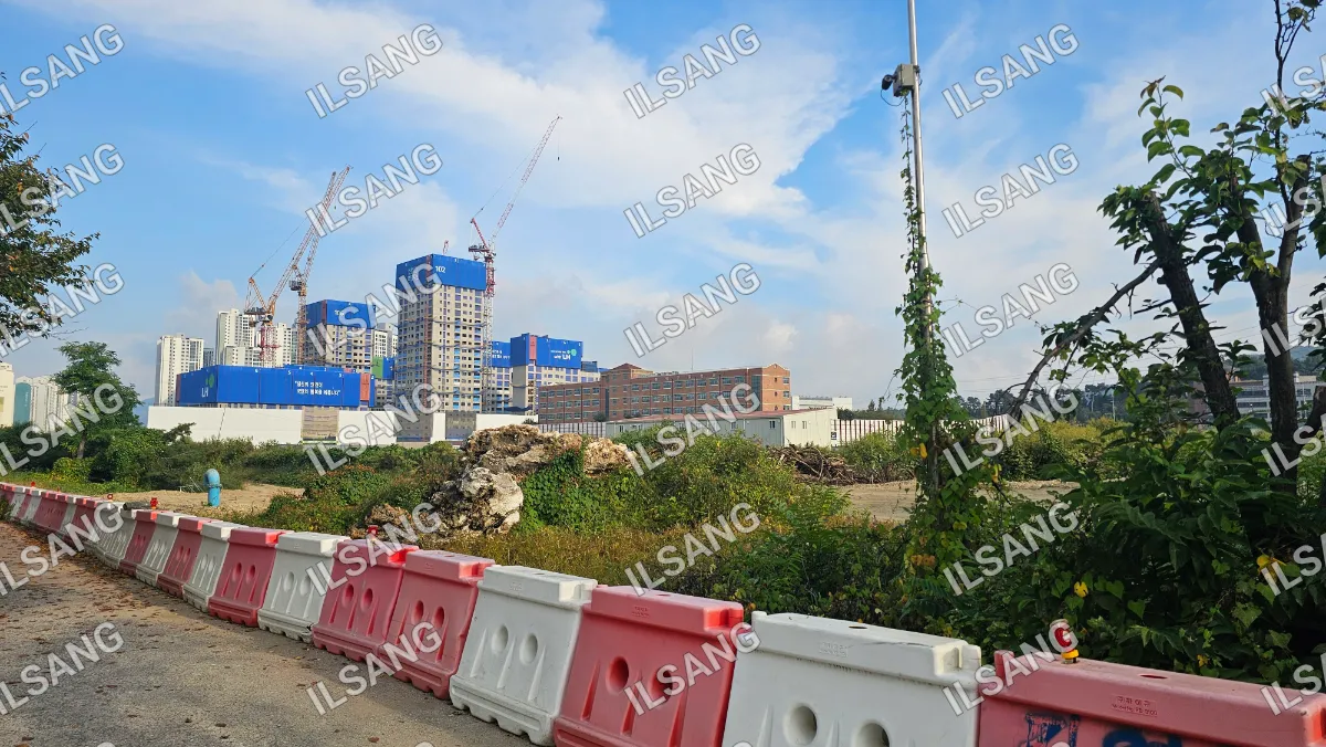 A construction site with a large building and a pile of rubble.