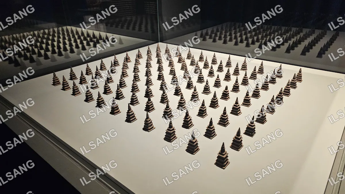 A display of small trees in a white box.
