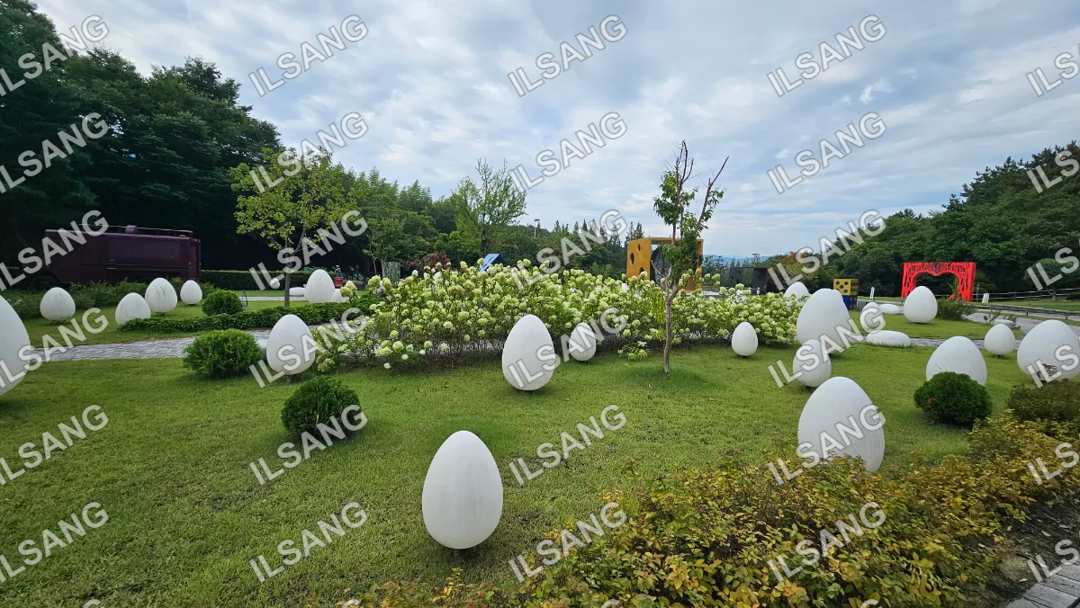A garden with white eggs and trees.