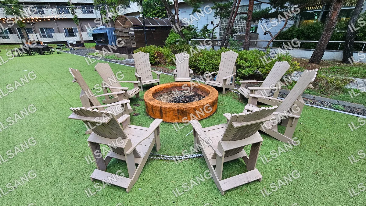 A group of chairs are arranged around a fire pit.
