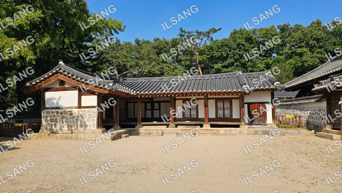A house with a tiled roof and a wooden fence.