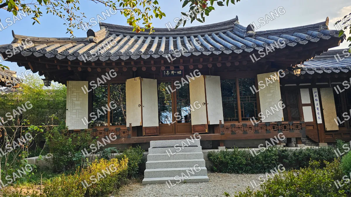 A house with a white roof and a wooden fence.