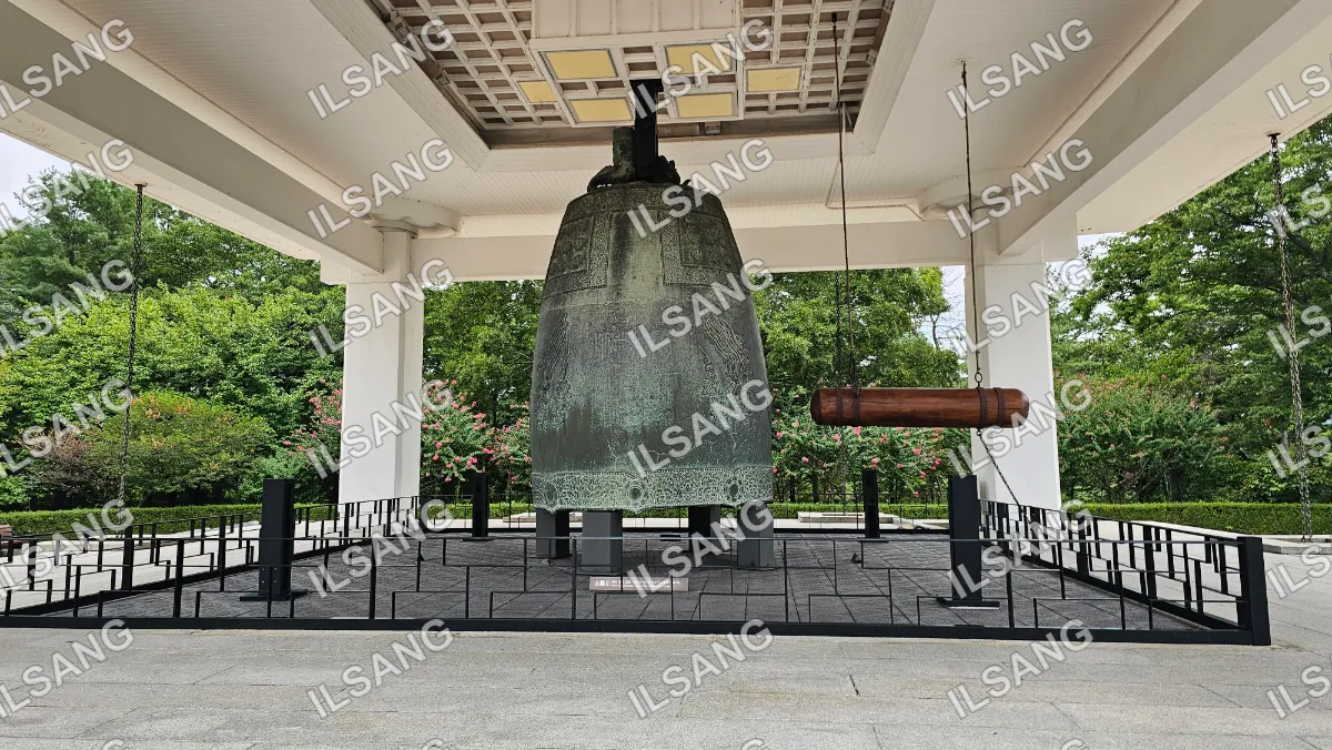 A large bell is on display in a building.