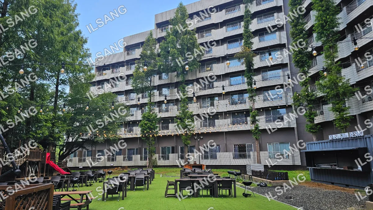 A large building with a patio area and many chairs and tables.