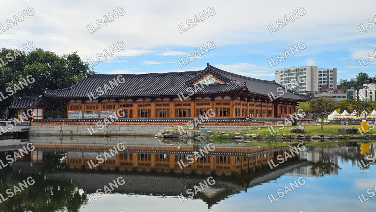 A large building with a reflecting pool in front of it.
