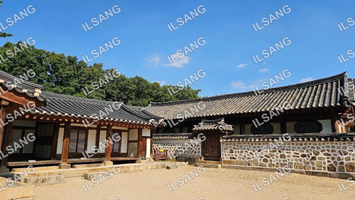 A large building with a stone roof and a wooden door.