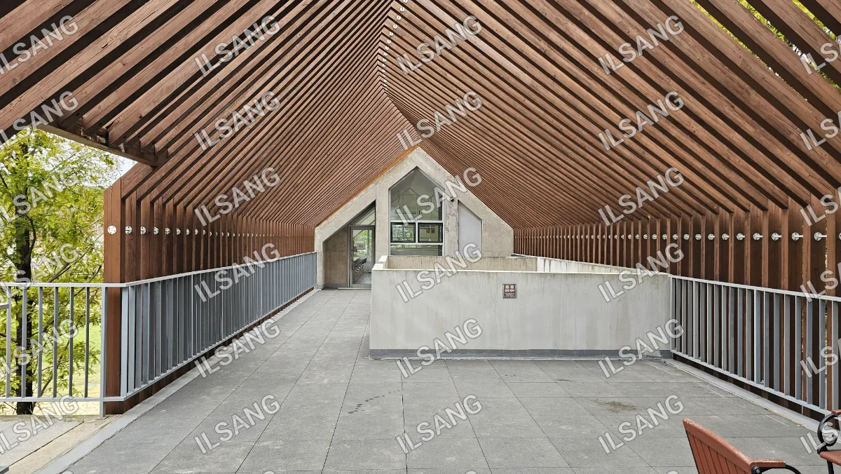 A large building with a wooden roof and a glass wall.