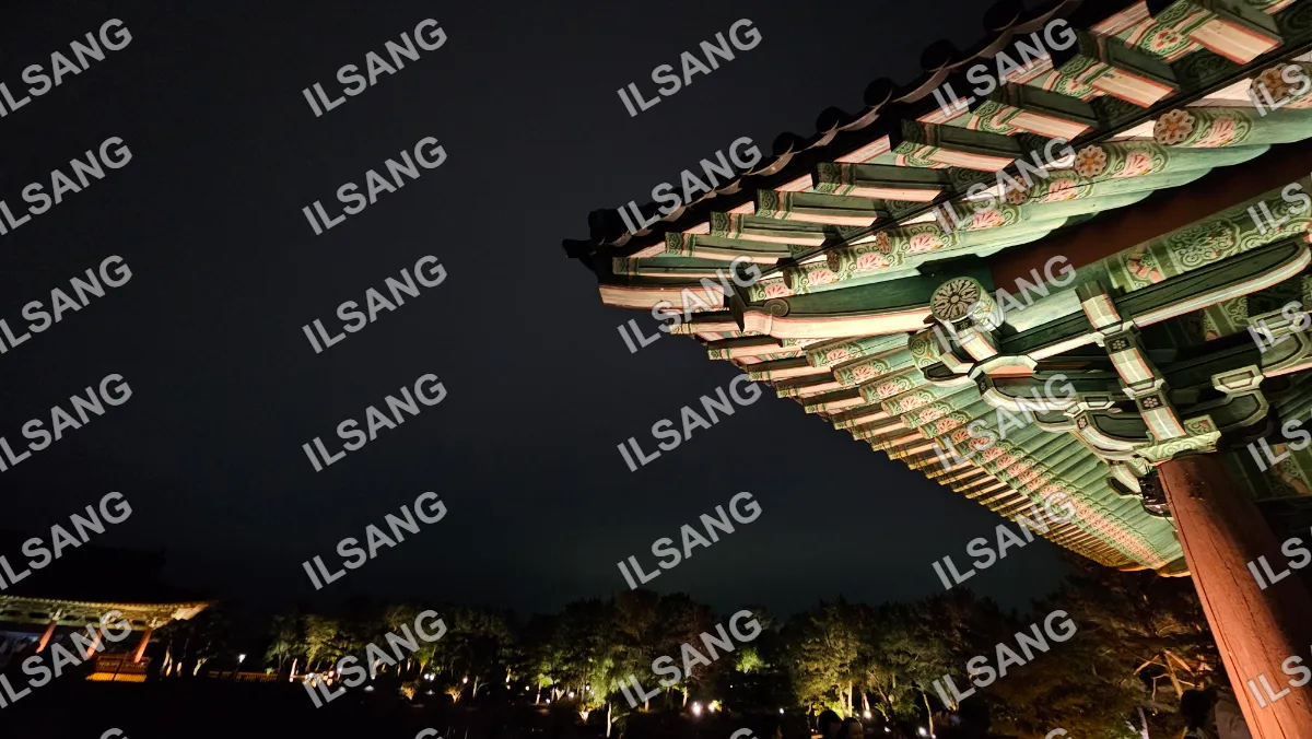 A large green roofed building with a pagoda style roof.