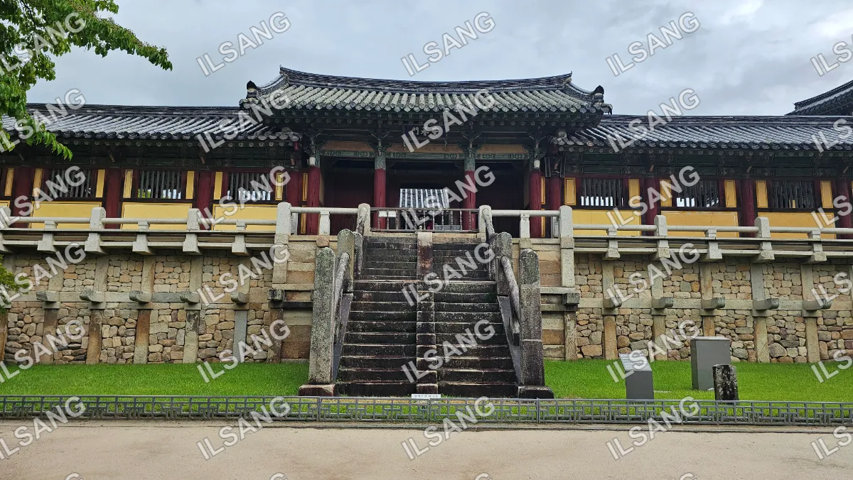 A large stone building with a staircase leading up to it.