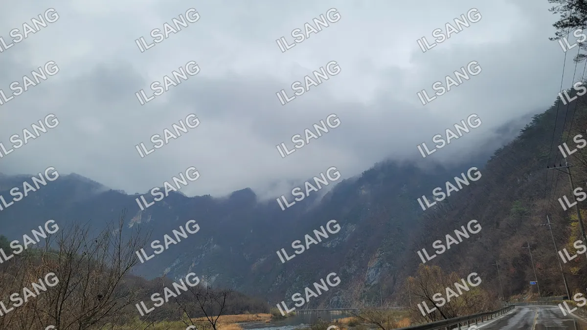 A mountain range with a cloudy sky above it.