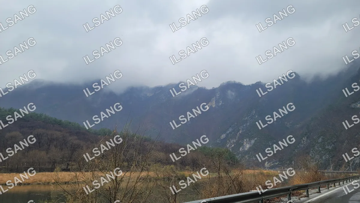 A mountain range with a cloudy sky above.
