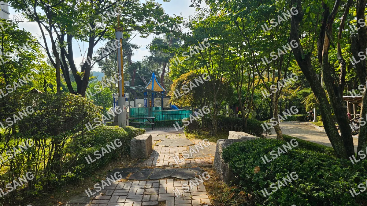 A park with a playground and a small pavilion.