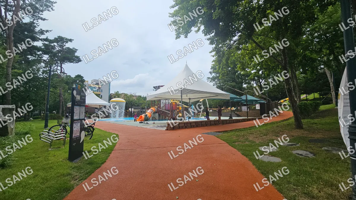 A park with a playground and a water slide.