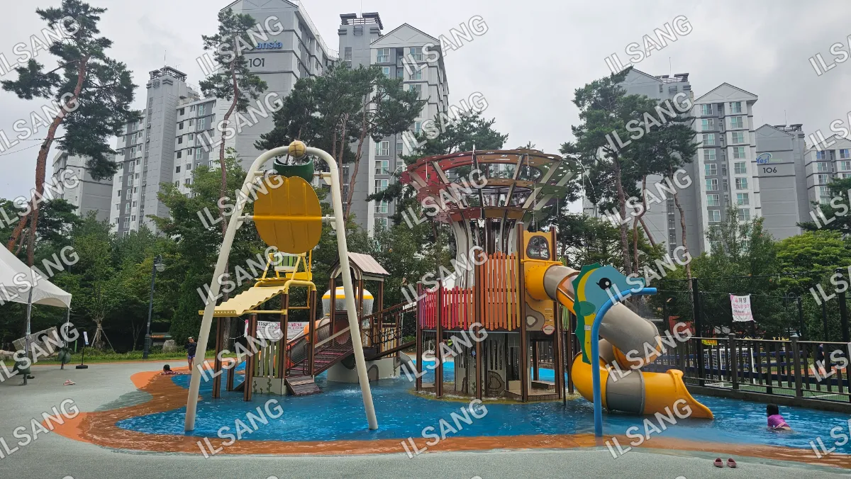 A playground with a slide and a swing in a city park.