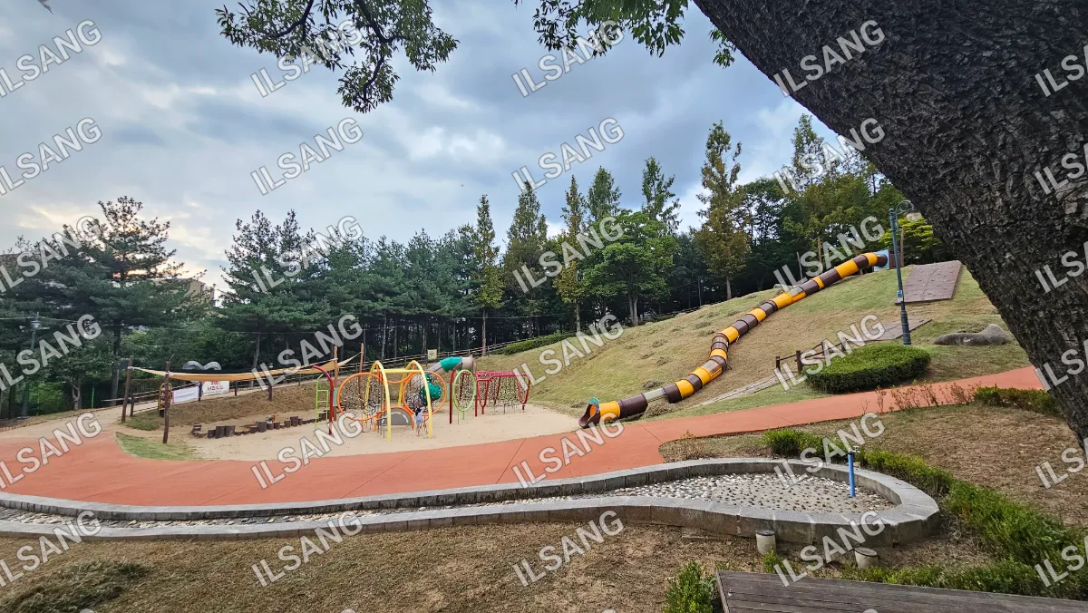 A playground with a slide and a swing set.