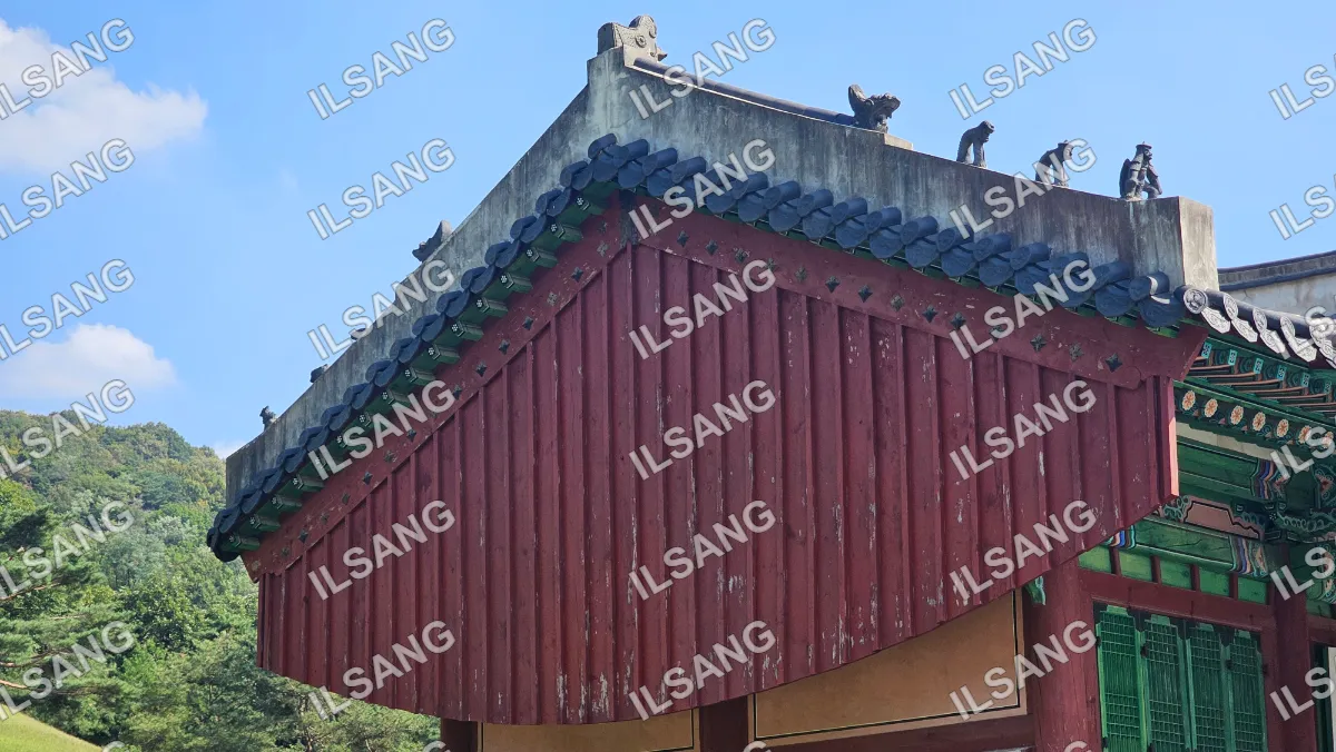 A red and green roofed building with a blue tile roof.