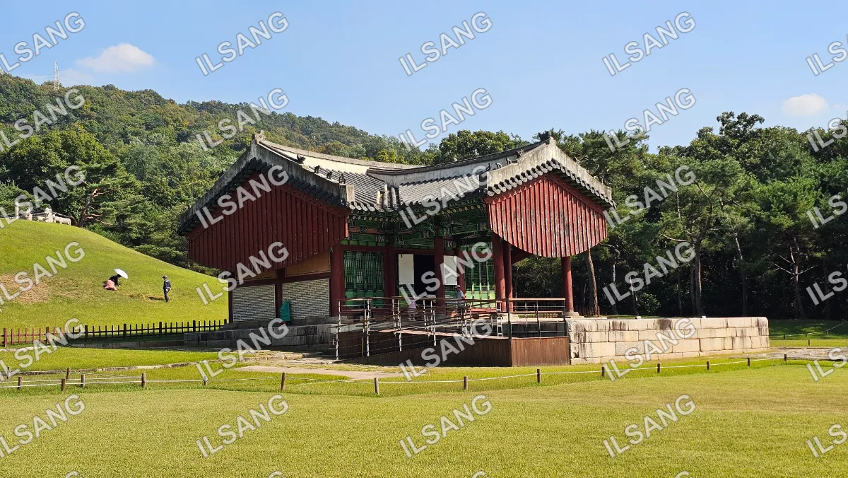 A red building with a green roof and a white roof.