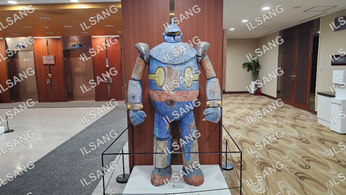 A robot statue is displayed in a museum.
