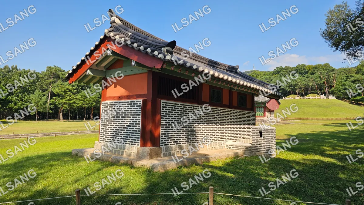A small brick building with a red roof.