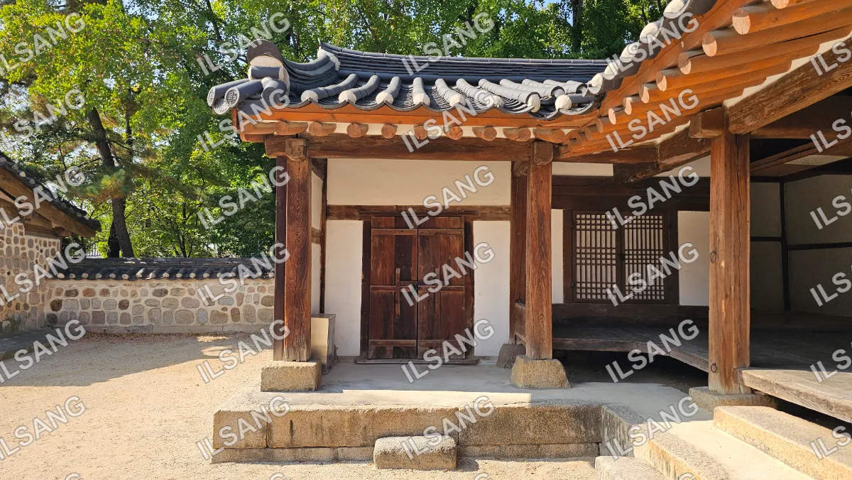 A small wooden building with a thatched roof.