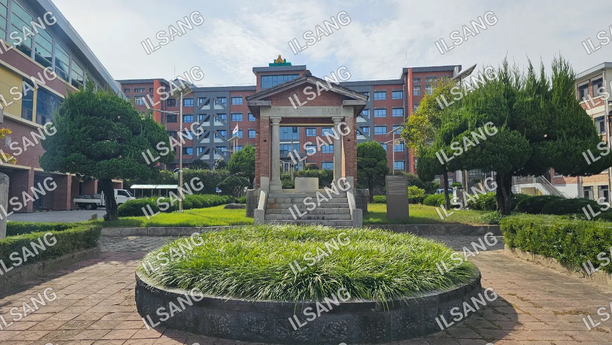 A statue is in the middle of a circular garden.