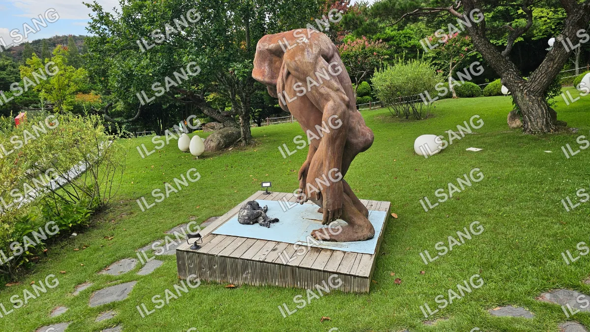 A statue of a man with a dog is on a pedestal.