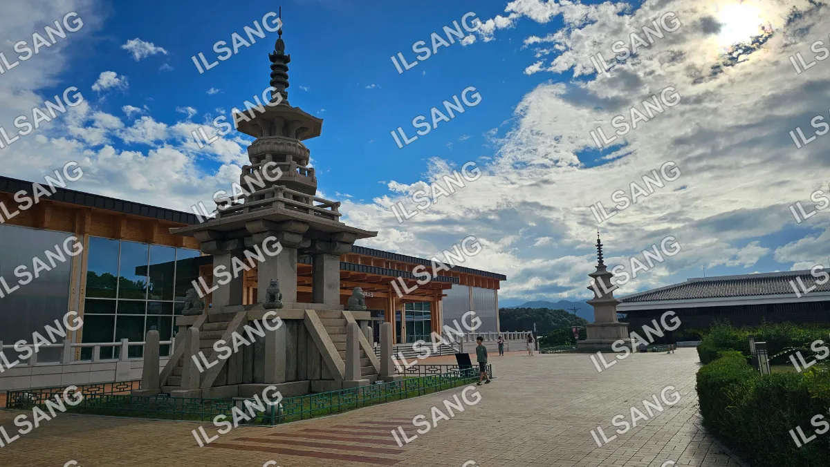 A statue of a pagoda in front of a building.