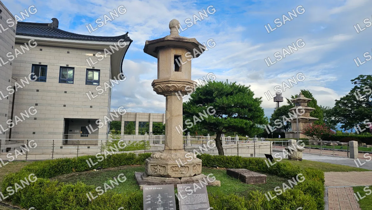 A stone statue with a roof on top of it.