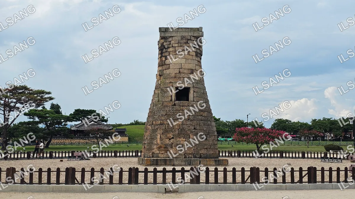 A stone tower with a doorway in the middle.