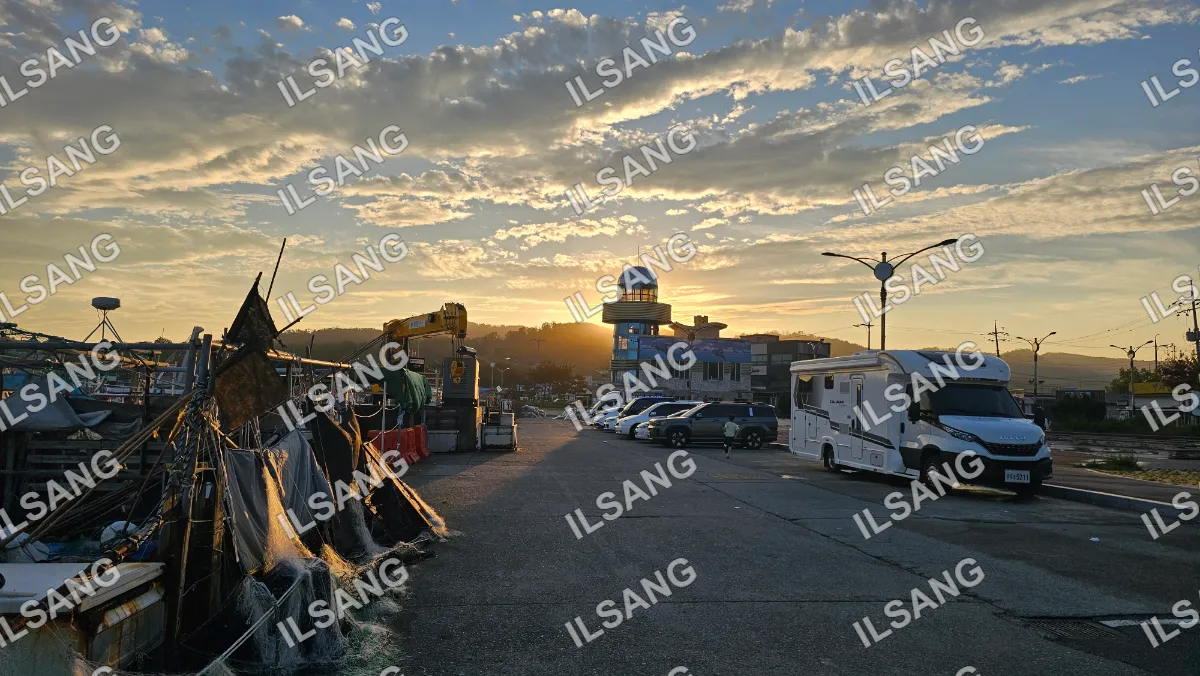 A street with a sunset and a construction site.