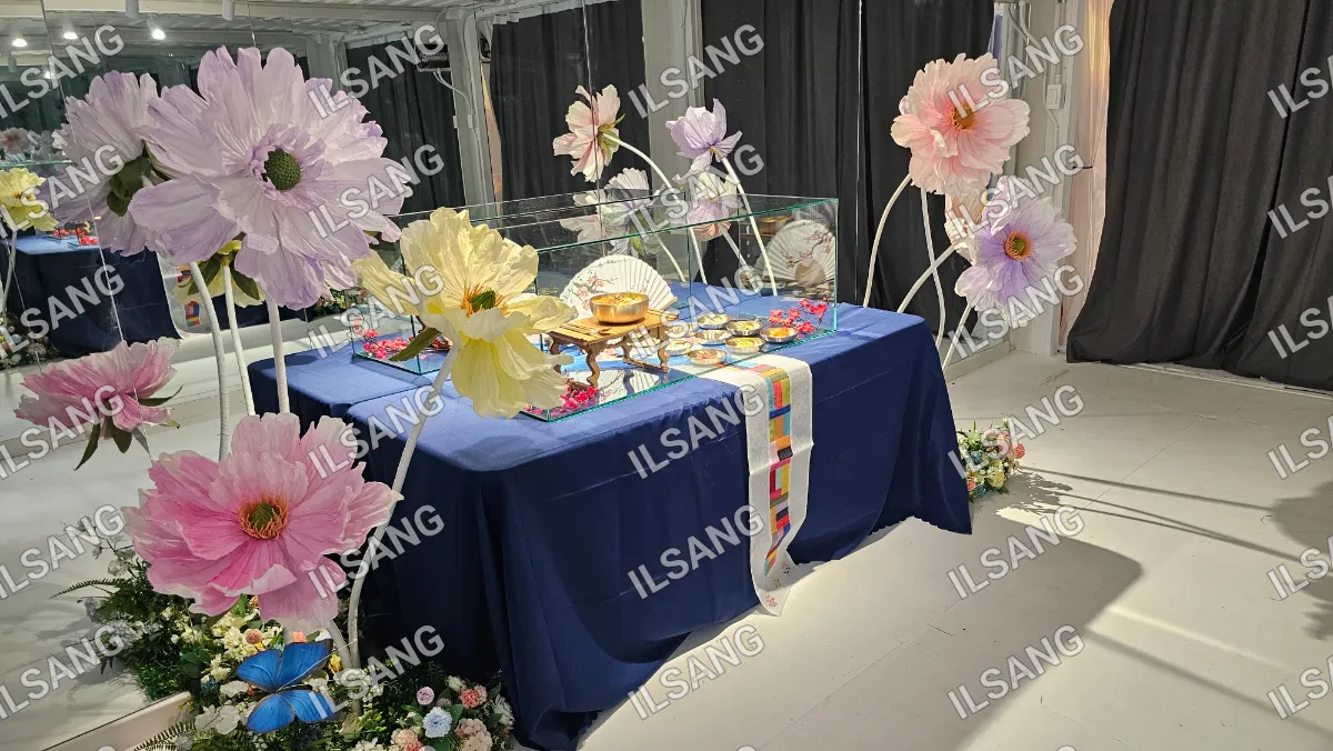 A table with a blue tablecloth and a white and blue striped tablecloth on it.