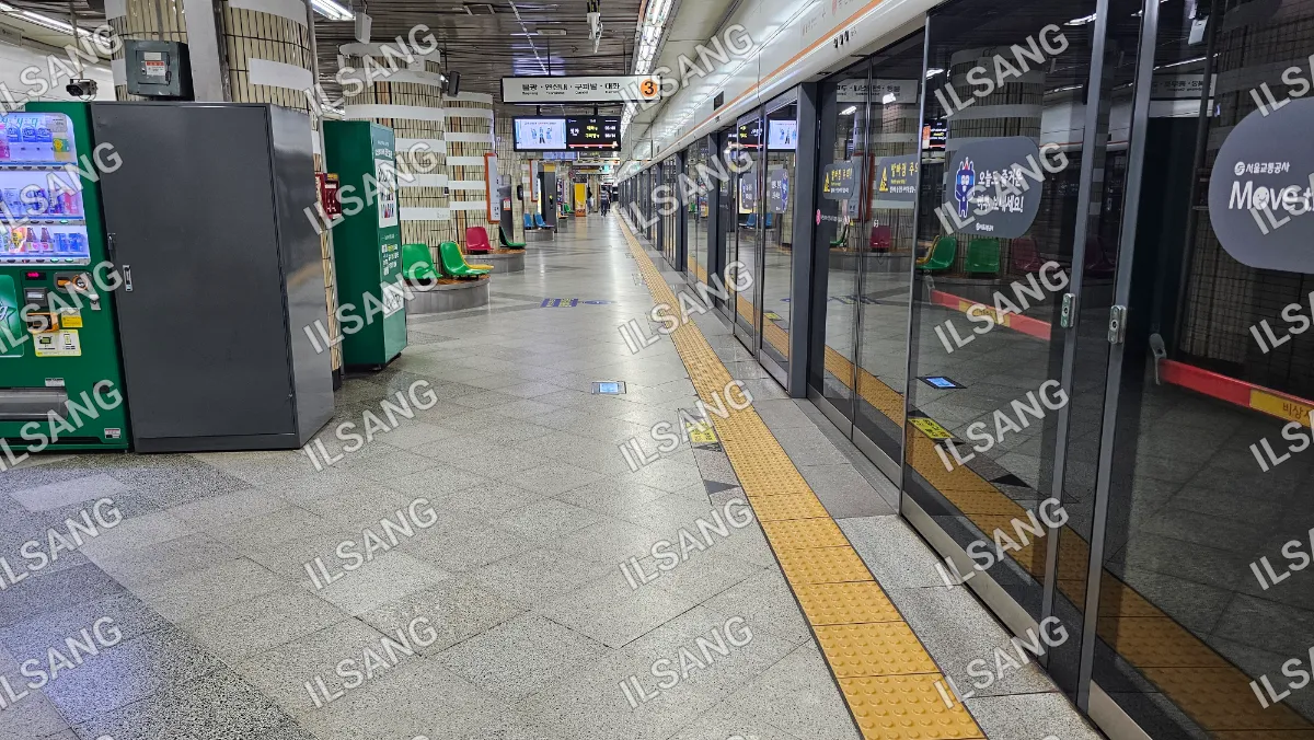 A train station with a train on the tracks.