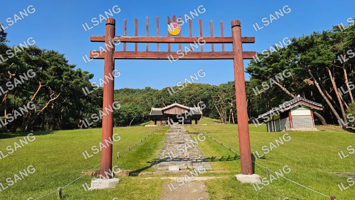 A wooden archway with a sign on top of it.