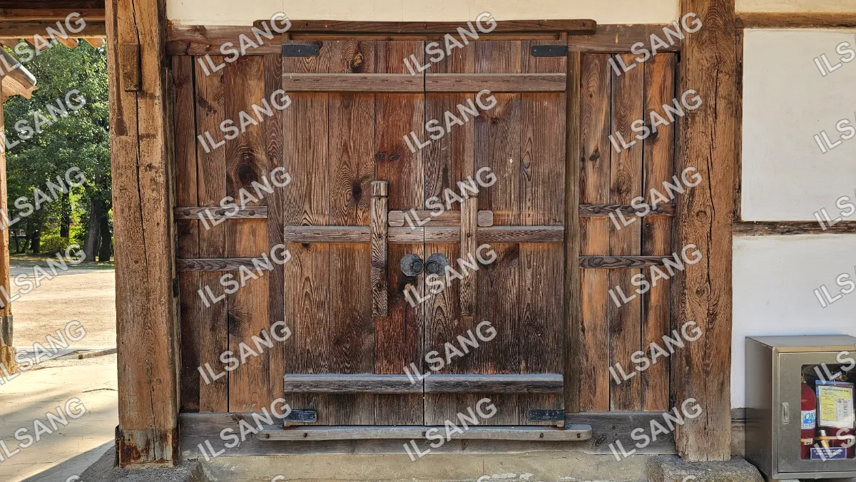 A wooden door with a large wooden frame.